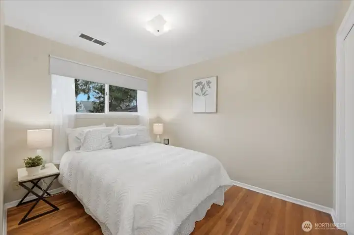 Second main floor bedroom offers a terrific view of the backyard, original Hardwoods, and is also just steps away from the full bathroom (another 3/4 bath available near 3rd bedroom).