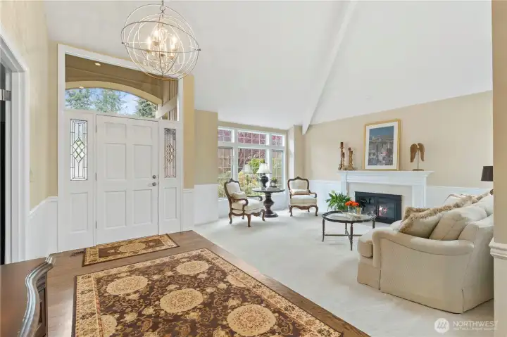 Upon entry, you’re welcomed by a formal family room anchored by a gas fireplace. Newly refinished hardwood floors, fresh wall-to-wall carpet, updated chandeliers, and fresh interior paint bring a polished feel throughout, while classic wainscoting adds timeless character and charm.