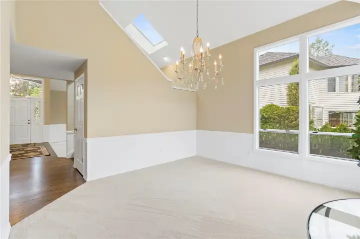 A formal dining room just off the kitchen offers a grand and spacious setting, ideal for hosting gatherings and special occasions.