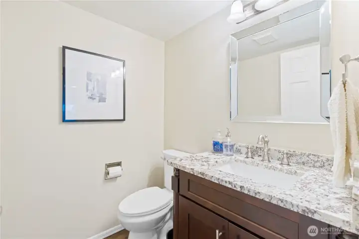 The powder room was remodeled in 2016 with updated fixtures and granite countertops, offering a clean and refined feel.
