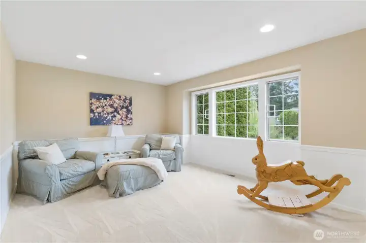 The expansive guest bedroom offers a range of possibilities—ideal as a bonus room or generous guest suite—complete with light-filled windows.