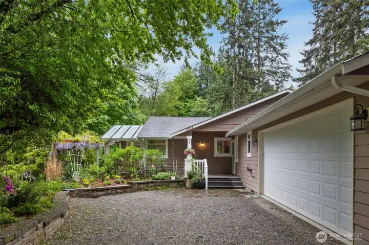 Beautifully landscaped approach welcomes you home.