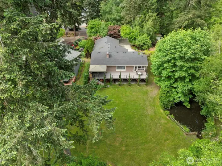A Property Meant to Be Explored. Featuring a peaceful trout-filled pond, open lawn areas, mature trees, and beautifully landscaped grounds connected to the nearby creek.