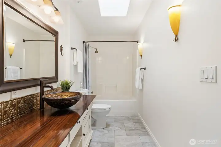 Spacious bath featuring unique designer details.