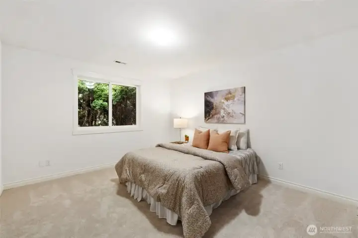 Comfortable guest bedroom with serene surroundings.