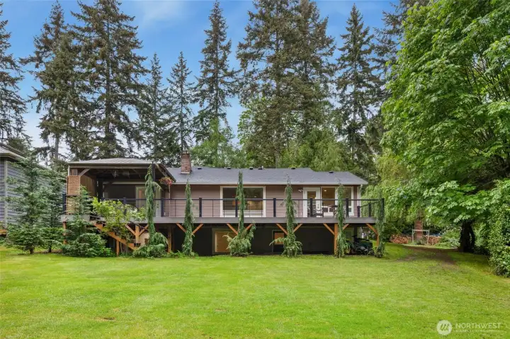 Spacious backyard and elevated deck create exceptional outdoor living.
