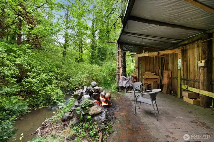 Rustic creekside gathering space perfect for evenings by the fire.