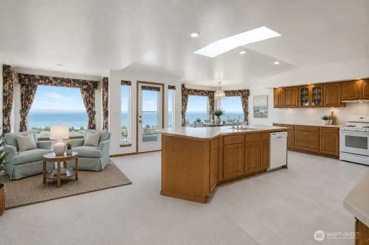 Virtually staged kitchen with both eating/sitting areas in the back by the windows