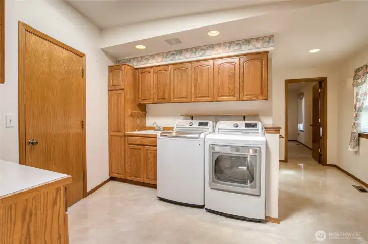 Laundry area is central to the house and right off the RV garage