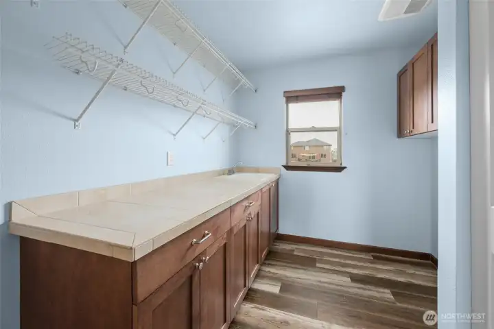 Laundry with storage and folding area. Laundry with storage and folding area.