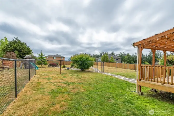 Fully fenced backyard with a designated dog run. Fully fenced backyard with a designated dog run.