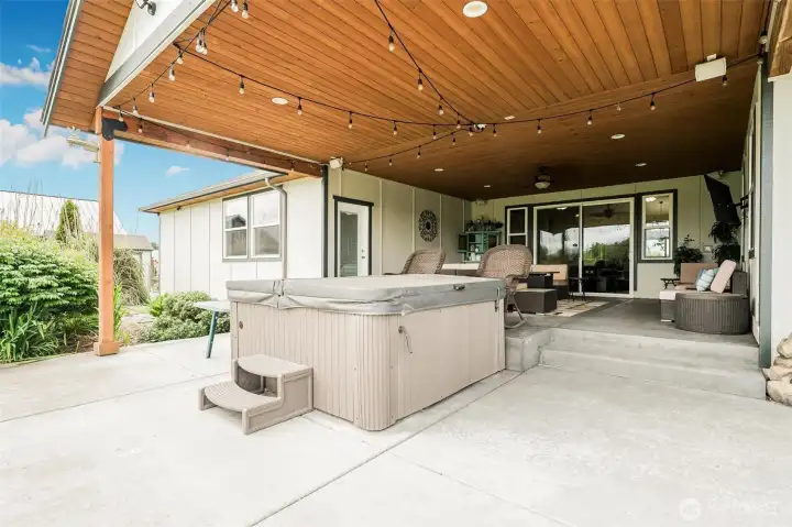 Covered patio just off of the primary bedroom and living room. Hot tub, mounted tv with seating area. Covered patio just off of the primary bedroom and living room. Hot tub, mounted tv with seating area.