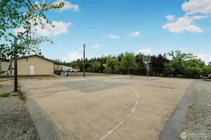 Sport court with adjustable basketball hoops and lighting for night games. Sport court with adjustable basketball hoops and lighting for night games.