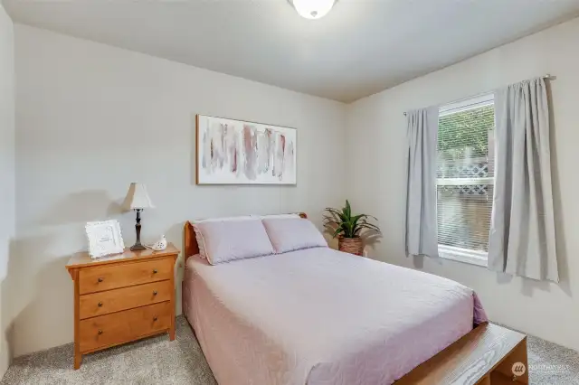 This additional bedroom offers plenty of space and natural light, making it ideal for guests or a home office.