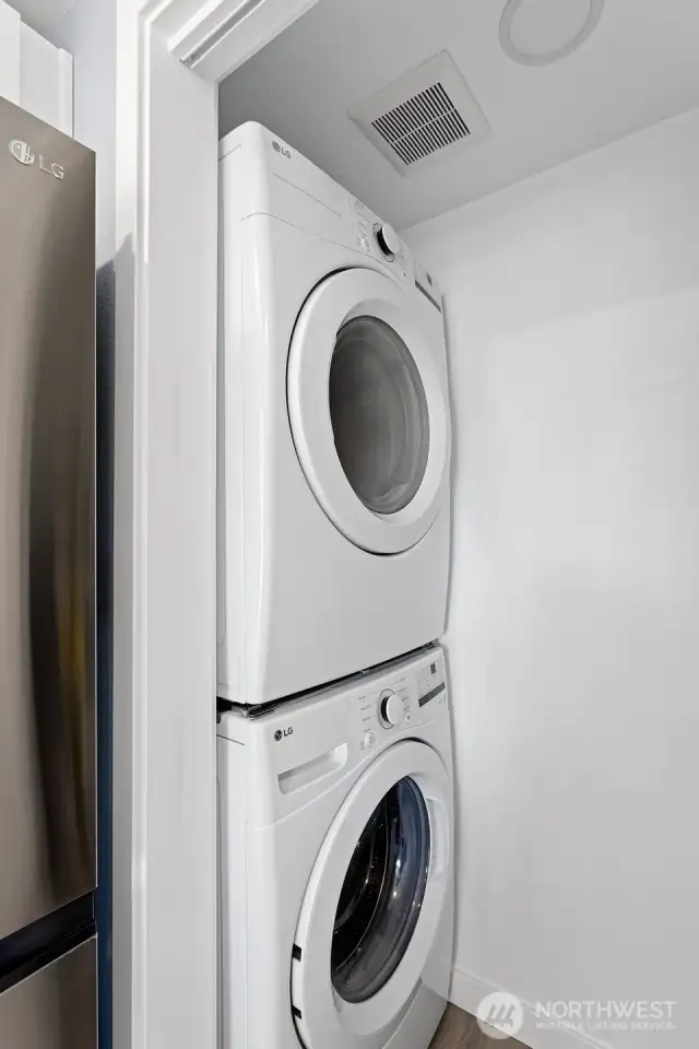 New LG stackable washer and dryer conveniently located in the utility closet.