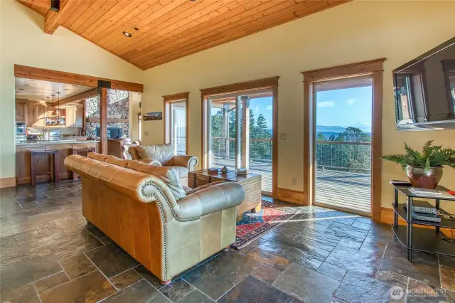 This view looks to the kitchen area from the dining area. More views and wrap-around deck.
