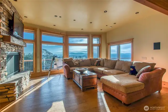 The media/bonus room on the lower level boasts its own atmosphere to showcase the views seen from the large widows in this room. Propane fireplace keeps everything cozy.