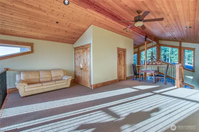 Upper loft area with 3/4 bath. Open on both ends brings in plenty of light. This could be office space, guest bedroom, yoga/art studio or a quiet library to enjoy a cozy book read.