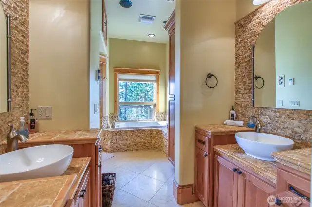 Lower level large bath includes bath/sauna, shower, dual wash basins.