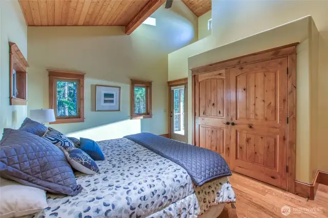 Vaulted ceiling and large closet/storage offered up in this 2nd bedroom ensuite on the main level. Doorway opens up to deck.