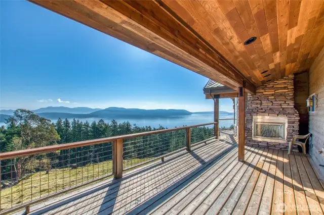 Wrap-around deck offers plenty of space to enjoy the view. Propane fireplace makes for cozy evening celebrations. This area of the deck is adjacent to one of two main bedrooms on main level.