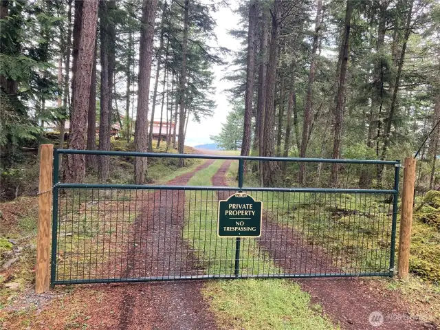 Gated driveway protects privacy at the end Pine Ridge Road.