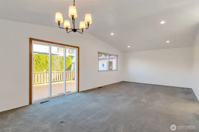 Living Room has nice slider out to the spacious deck and gas bbq