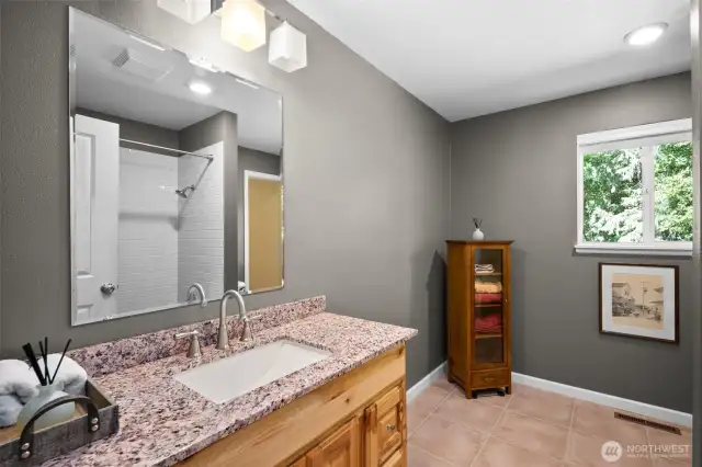Full bathroom,  toilet behind the shower wall