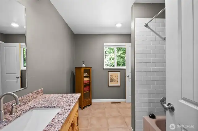 Full bathroom,  toilet behind the shower wall