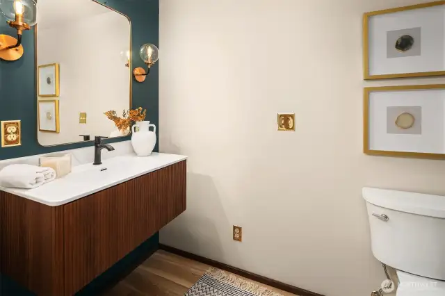 Updated bathroom with new vanity, toilet and light fixtures.
