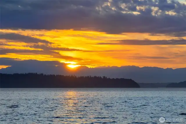 Mesmerizing sunsets over the islands and Olympics.