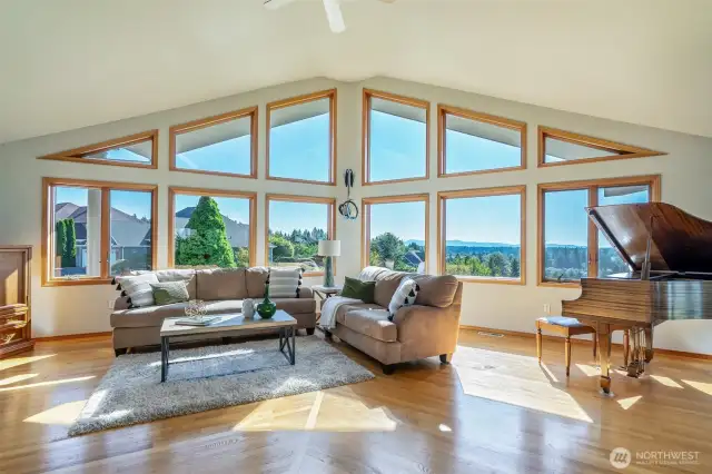 Soaring ceilings and a wall of windows flood the great room with natural light while perfectly framing sweeping views of the Black Hills, Olympics, and Mt. Rainier. A stunning architectural statement and serene gathering space in one.  Soaring ceilings and a wall of windows flood the great room with natural light while perfectly framing sweeping views of the Black Hills, Olympics, and Mt. Rainier. A stunning architectural statement and serene gathering space in one.