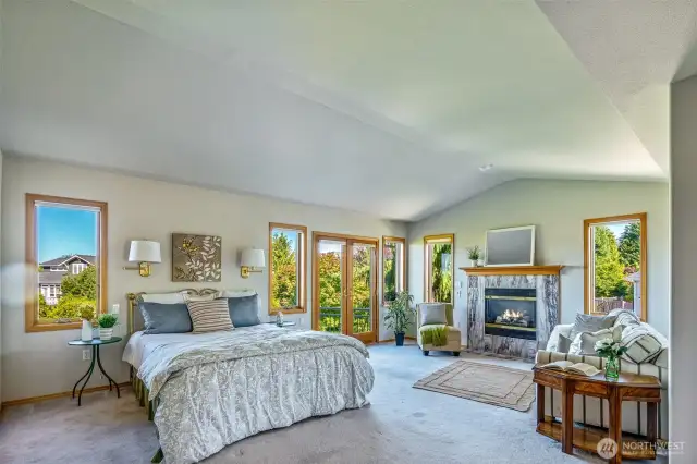 The grand Primary Suite offers space to truly unwind—complete with a marble-surround fireplace, sitting nook, abundant natural light, and French doors to your own outdoor escape.
