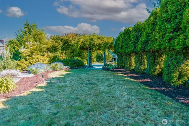 ge backyard with room to roam! Landscaped beds, privacy screening, and a whimsical arbor create the perfect blend of beauty and function.