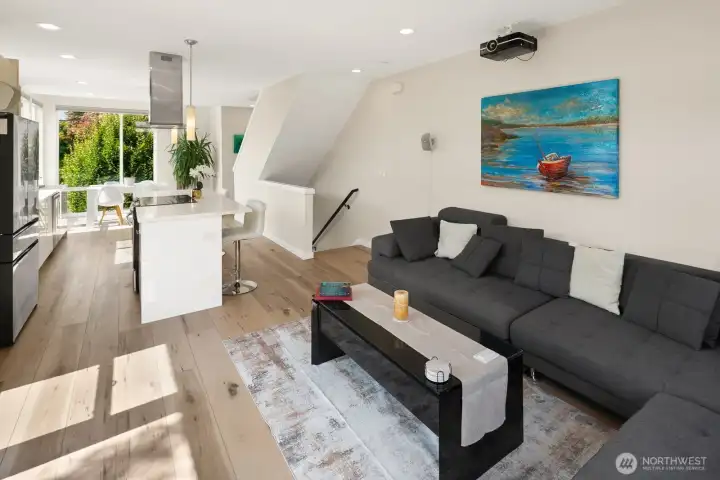 Living room opening to kitchen and dining