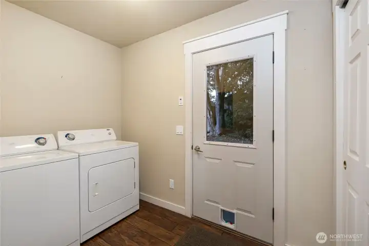 laundry room off the kitchen, with storage closet and door to back yard & off street parking.