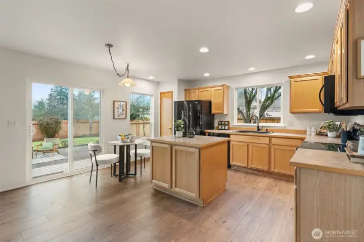 Sliding glass doors offer direct access to the patio, making indoor-outdoor flow simple for dining and entertaining. The nearby breakfast nook adds flexibility for everyday use.