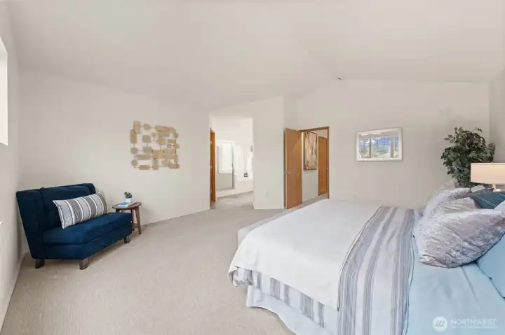 This view highlights the generous footprint of the room, offering space for a sitting area and easy flow to the en-suite bath.
