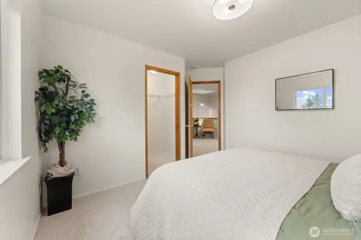 This view highlights the convenient walk-in closet, offering generous storage and built-in lighting for easy organization. The layout provides a smooth transition between the bedroom and closet while maintaining a clean, functional flow.