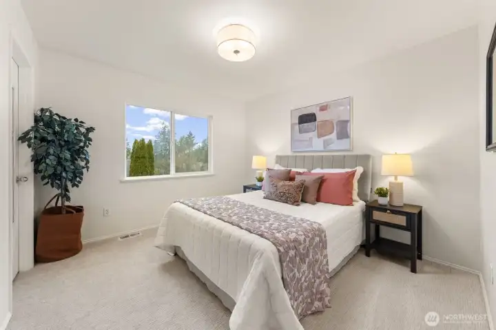 Bedroom 3 features soft carpet and a large window that brings in great daylight and outdoor views and fresh paint. A walk-in closet adds convenient storage, making this room both comfortable and functional for everyday use or guests.