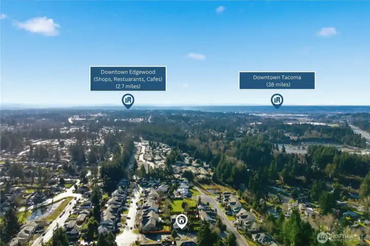 Expansive aerial view illustrating the home’s location near Downtown Edgewood’s shops and dining, with regional access toward Downtown Tacoma.
