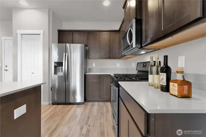 Kitchen view three from dining area, plenty of counter space and cabinets for storage.
