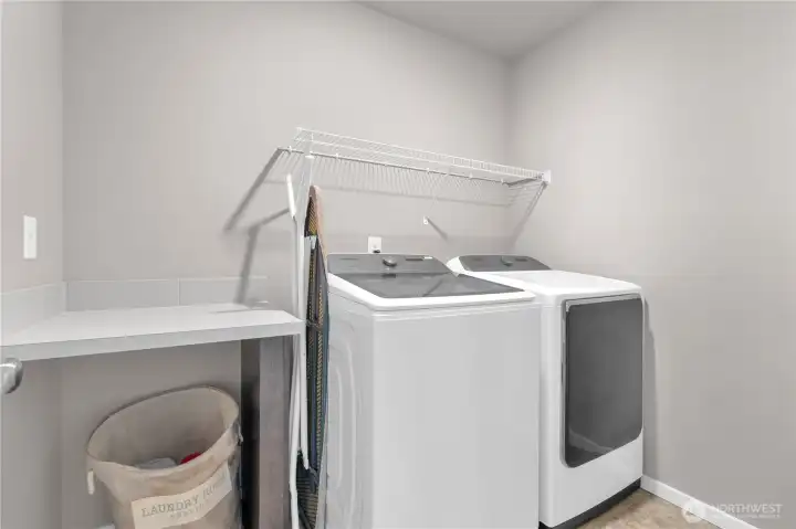 Upstairs laundry, SO convenient! Love the folding table and storage rack.