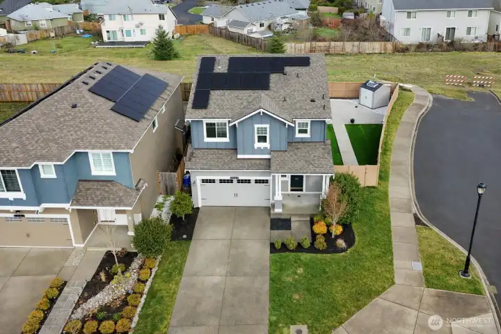 Drone view of the front of the property, newer solar panels! Dead-end right next door offers additional parking for you and your guests.