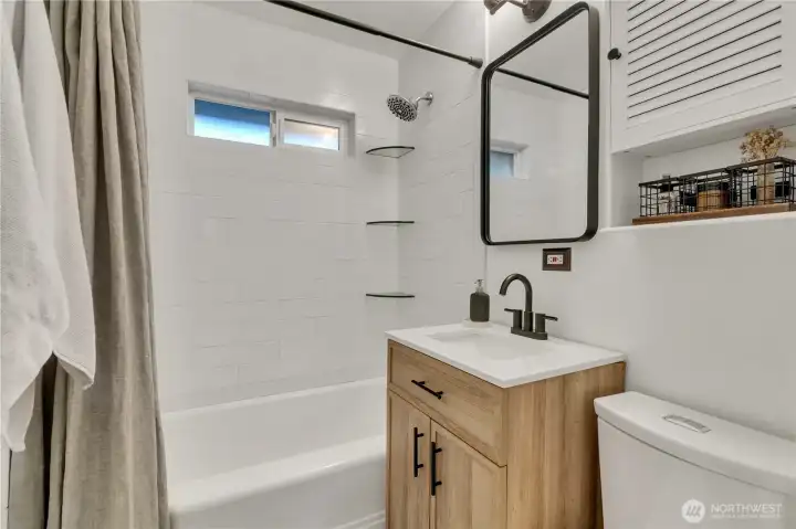 Remodeld main bath with tiled shower surround