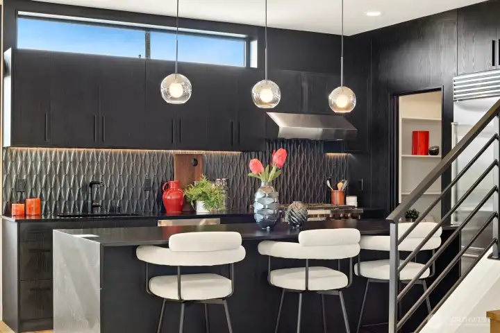 Entertainment sized island with leather ablsolute black granite countertops.