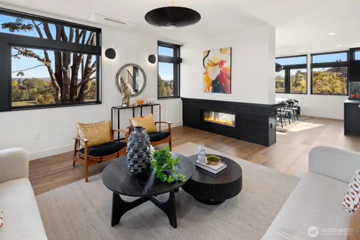 Living room has see-through fireplace separating living room from dining area.