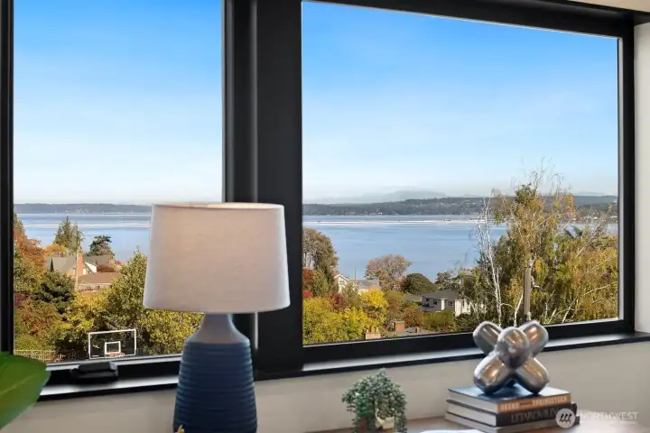 One of the upper bedrooms is staged as an office. It overlooks the lake and City of Bellevue skyline view in the distance.