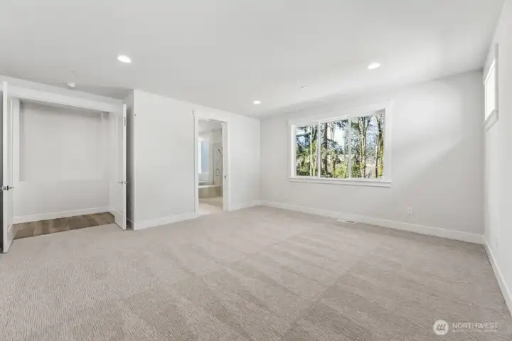 Large primary suite that looks out to the trees
