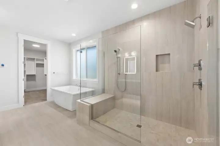 Spa like primary bath with heated floors, soaking tub, and massive walk-in shower